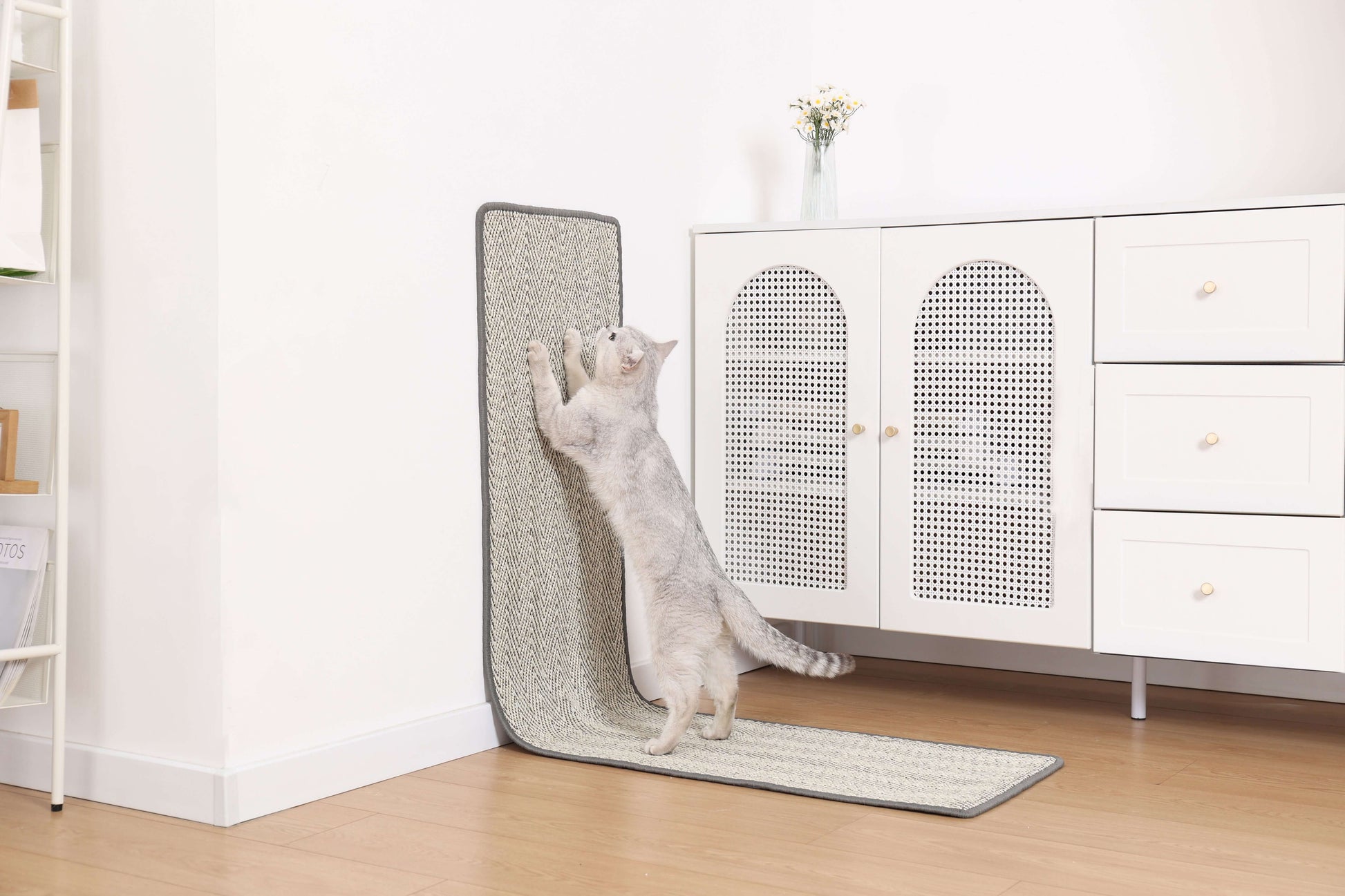 Cat stretching on a vertical Boho-style scratchable runner in a modern living room setting.