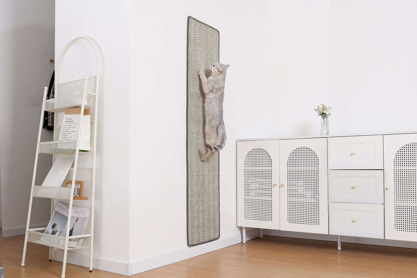 Cat using Boho-Style Scratch-able Runner on wall, promoting stretching and exercise in minimalist living room setting.